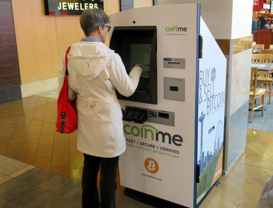 Woman using a Coinme Bitcoin kiosk