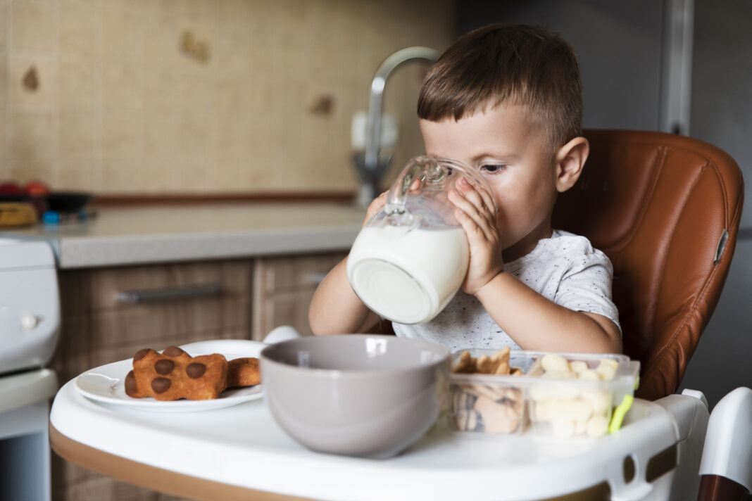 Young boy drinking milk
