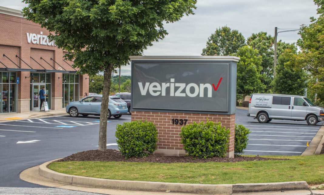 A Verizon sign in front of a parking lot for one of its buildings in Snellville