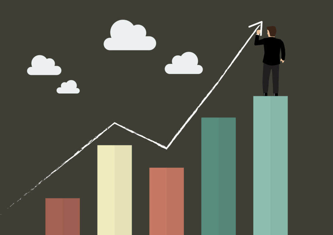 Businessman drawing growth line