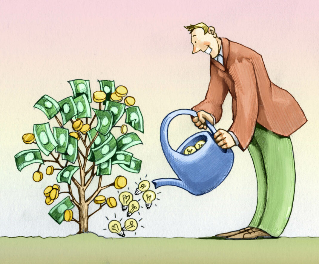 Businessman watering plant