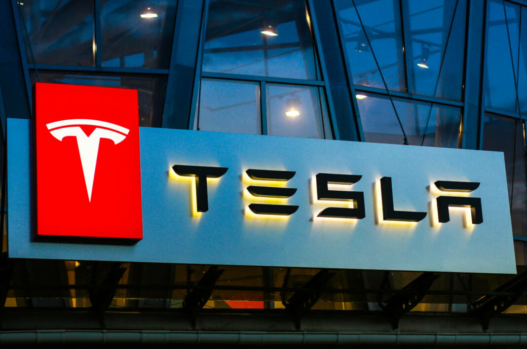 Tesla sign on a car sales building in Concha Zaspa