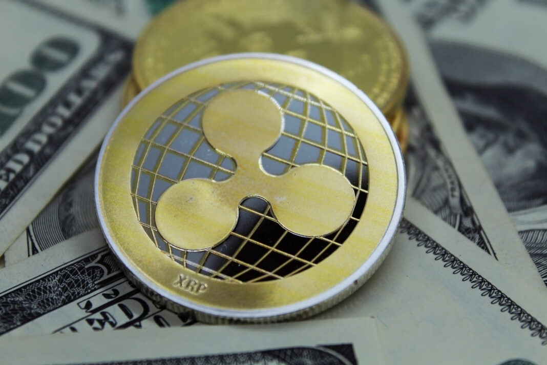 Ripple Coin and banknotes.Ripple crypto-currency on dollar notes.