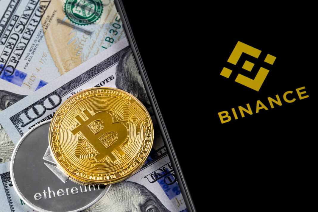 Binance logo and bitcoin, ethereum and dollars