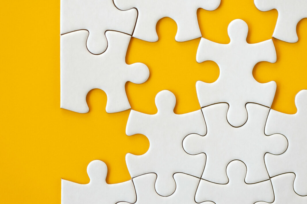 Puzzle pieces on orange background
